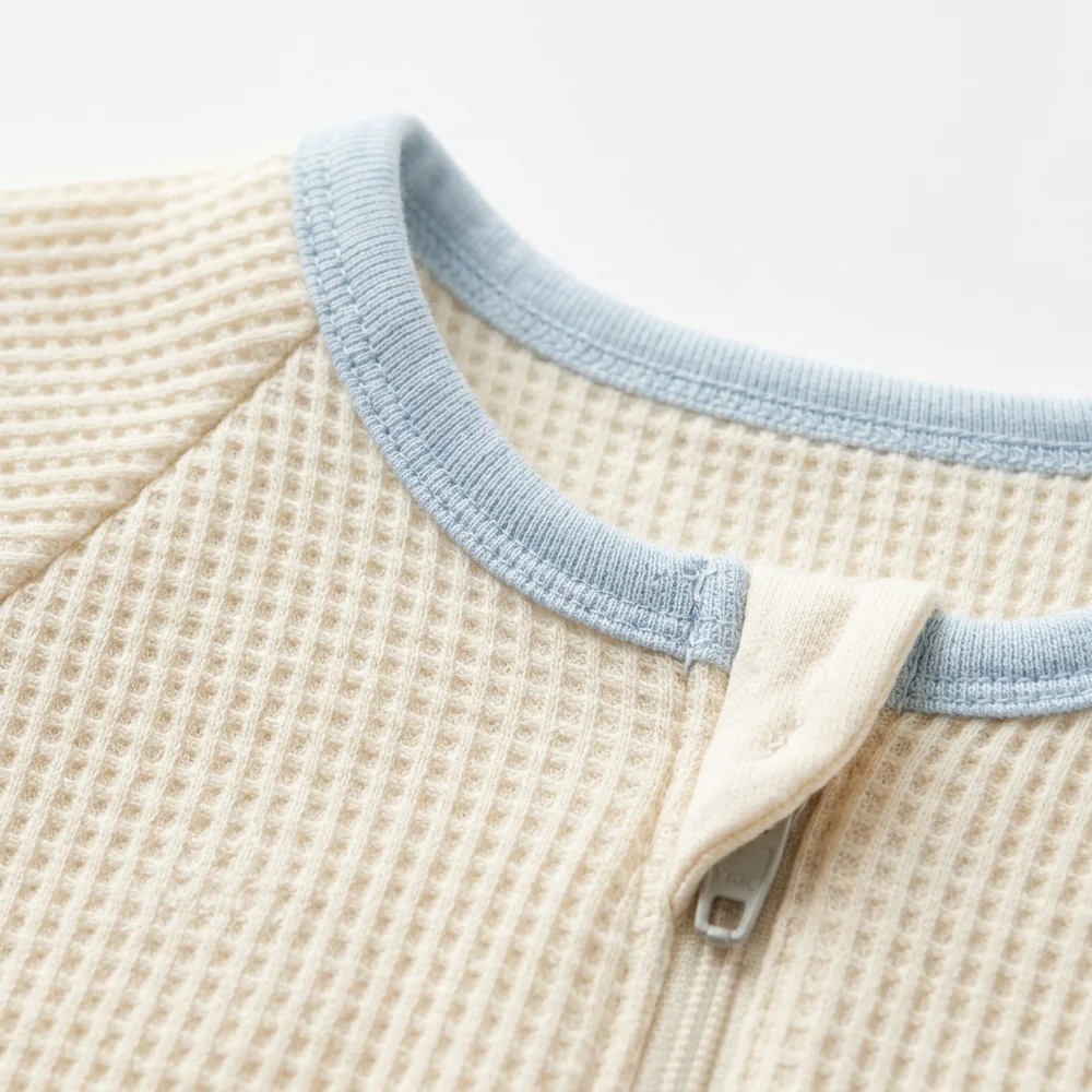 Macro of the honeycomb knit, blue trim and zipper